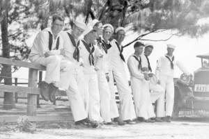 Sailors leaning on fence