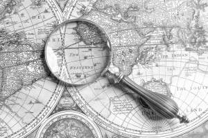 Magnifying glass on ancient map