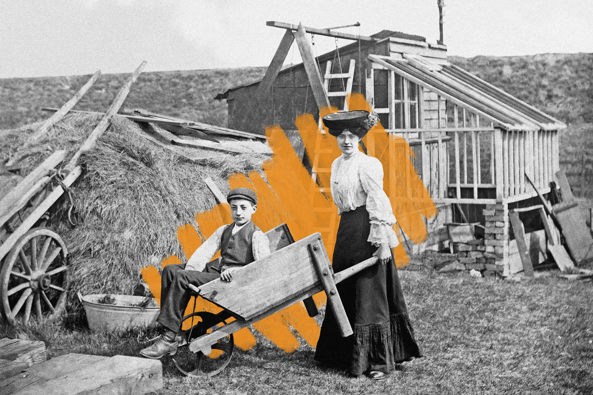 Woman pushing wheelbarrow, c. 1900